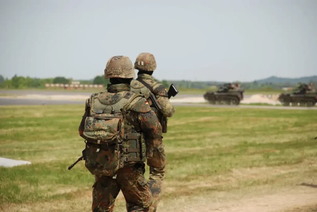 Spezialeinheit der Bundeswehr in Tarnausrüstung von hinten bei einer taktischen Übung im Freien